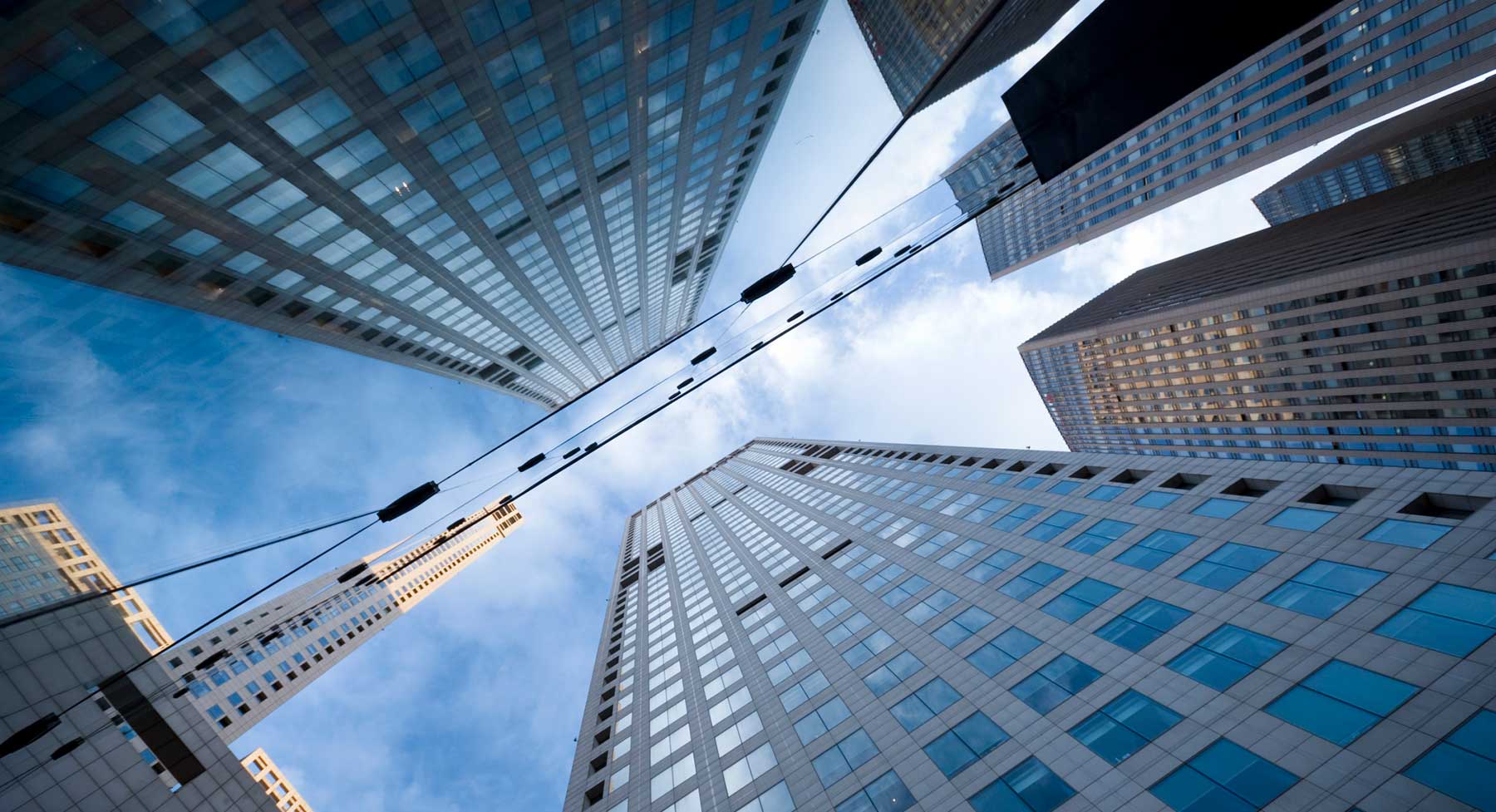 upward view of skyscrapers against a blue sky